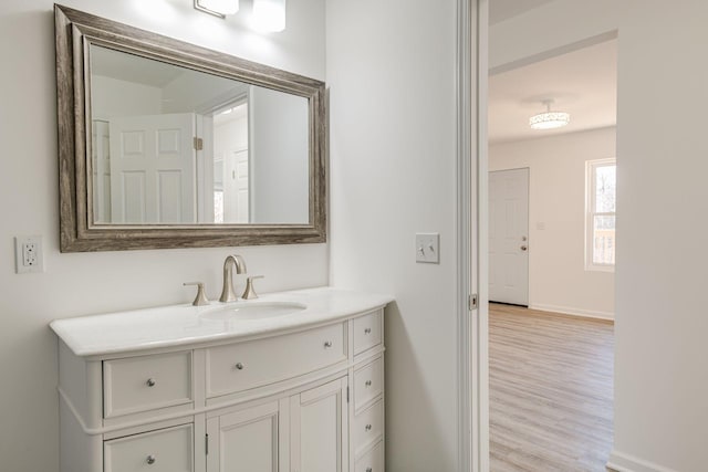 bathroom with hardwood / wood-style floors and vanity