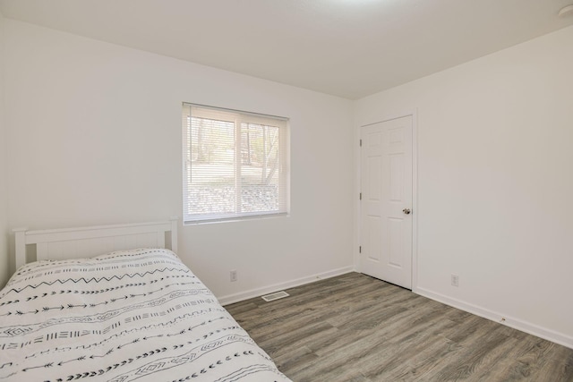 bedroom with hardwood / wood-style floors