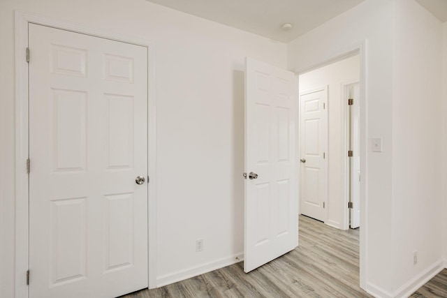 unfurnished bedroom featuring light wood-type flooring