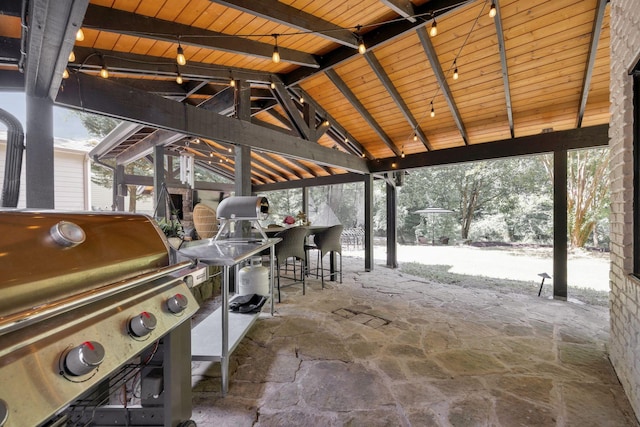 snow covered patio featuring a gazebo, a grill, and a bar