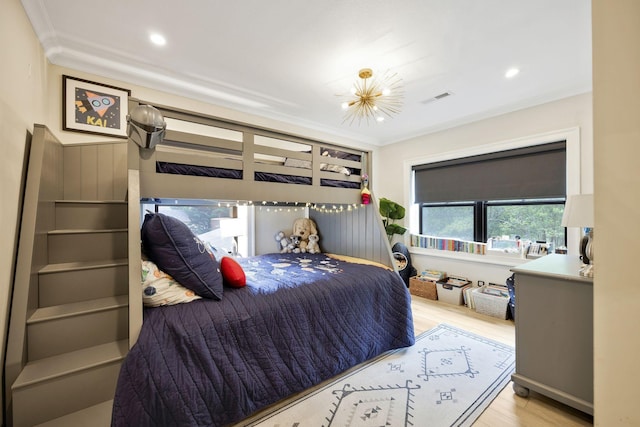 bedroom featuring light hardwood / wood-style floors and ornamental molding