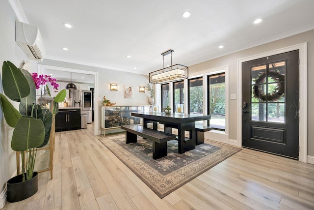 dining room with light hardwood / wood-style floors, an AC wall unit, and ornamental molding