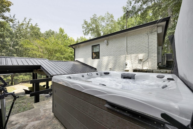 exterior space with a hot tub