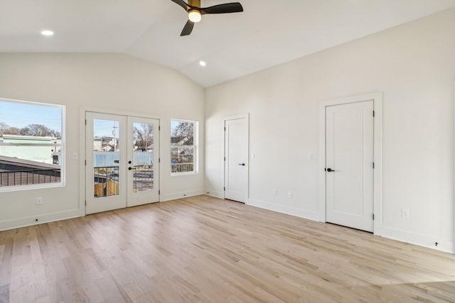 unfurnished room featuring ceiling fan, vaulted ceiling, light hardwood / wood-style flooring, and french doors