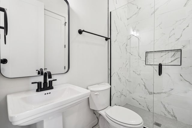 bathroom with an enclosed shower, toilet, and sink