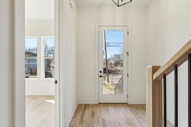 doorway to outside featuring light hardwood / wood-style floors and a wealth of natural light