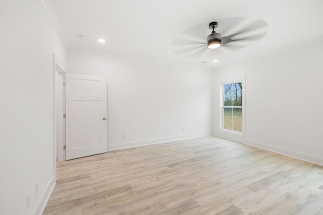 spare room featuring light wood-type flooring, ceiling fan, and ornamental molding