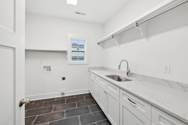 clothes washing area with sink, cabinets, hookup for an electric dryer, hookup for a washing machine, and dark tile patterned flooring