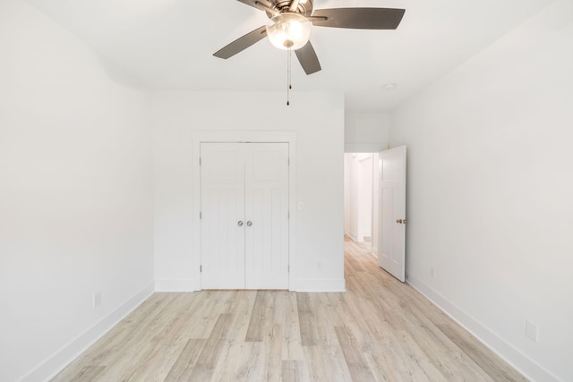 unfurnished bedroom with ceiling fan, a closet, and light wood-type flooring