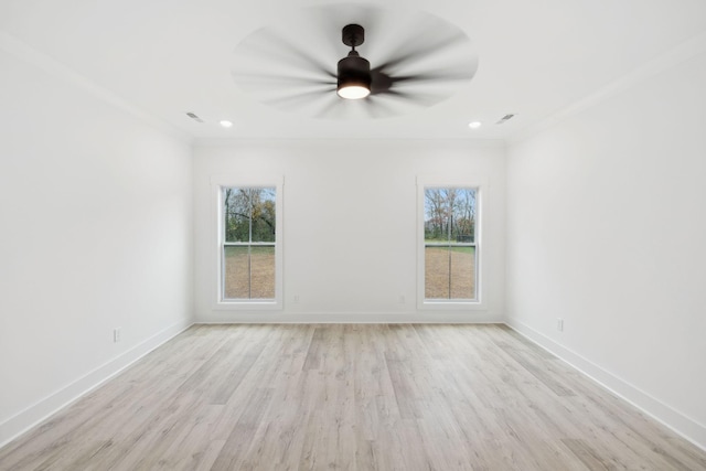 unfurnished room with light hardwood / wood-style flooring, a wealth of natural light, and crown molding