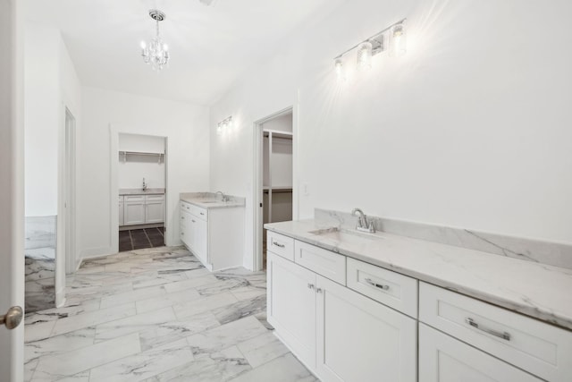 bathroom featuring vanity and an inviting chandelier