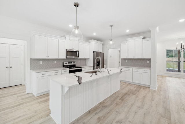 kitchen featuring white cabinetry, pendant lighting, light wood-type flooring, and appliances with stainless steel finishes