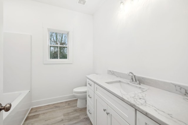 full bathroom featuring separate shower and tub, toilet, vanity, and hardwood / wood-style flooring