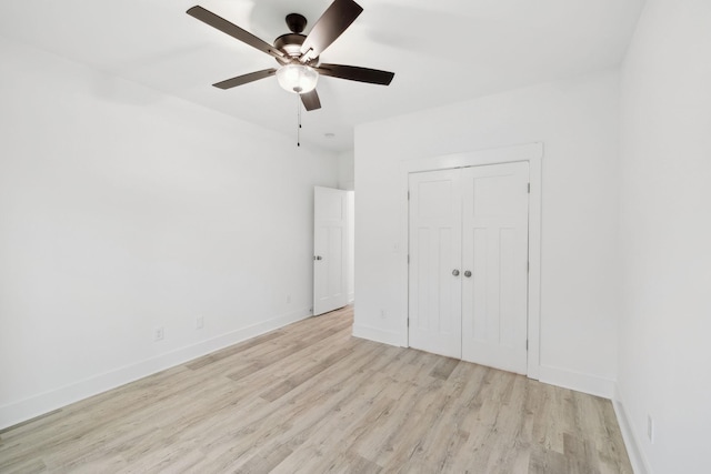 unfurnished bedroom with ceiling fan, a closet, and light hardwood / wood-style floors