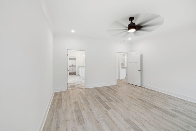 unfurnished room featuring ceiling fan, light hardwood / wood-style floors, and crown molding