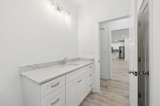 bathroom with hardwood / wood-style floors and vanity