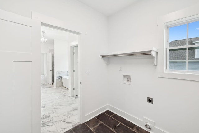 laundry area featuring hookup for an electric dryer, hookup for a washing machine, and an inviting chandelier