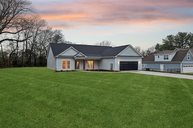 view of front of property featuring a lawn and a garage