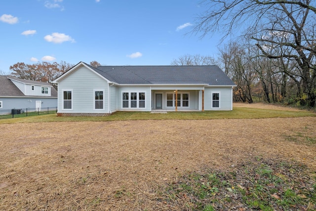 rear view of house with a lawn