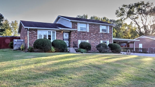 view of front facade featuring a carport and a lawn