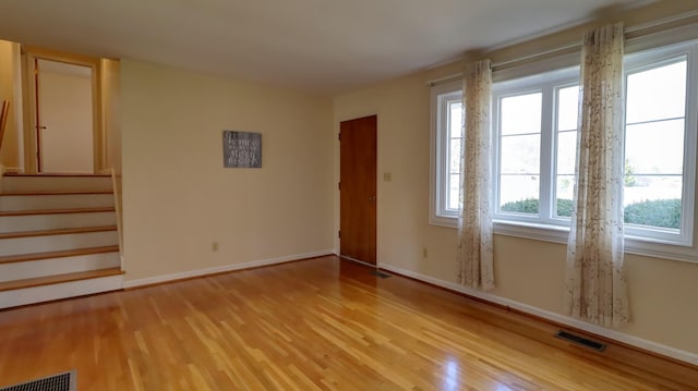 unfurnished room with light wood-type flooring