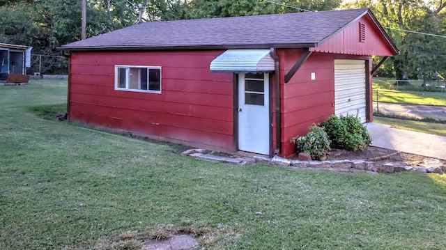 view of outbuilding featuring a yard