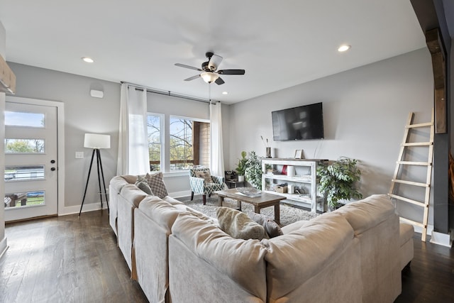 living room with ceiling fan and dark wood-type flooring