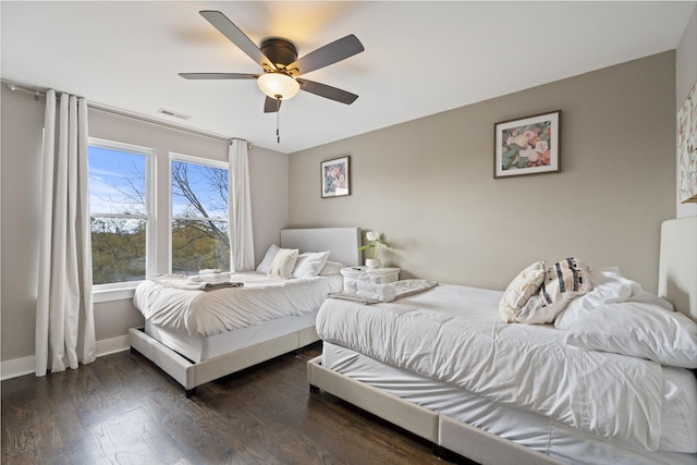 bedroom with ceiling fan and dark hardwood / wood-style flooring