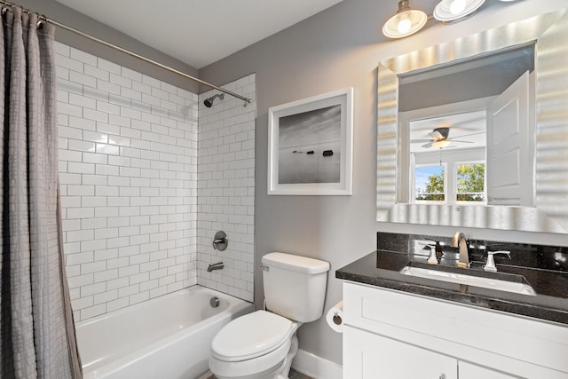 full bathroom featuring vanity, shower / bathtub combination with curtain, toilet, and ceiling fan