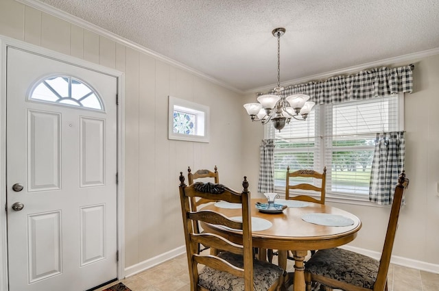 dining area with a textured ceiling, wooden walls, ornamental molding, and a notable chandelier