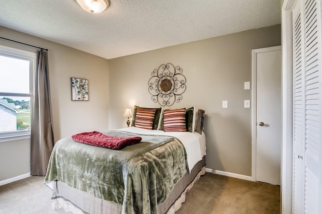 carpeted bedroom with a textured ceiling