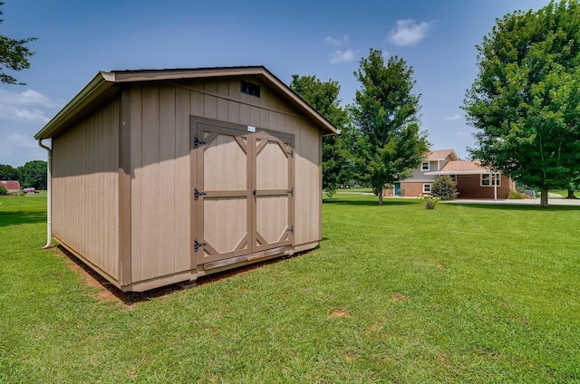 view of outbuilding with a yard