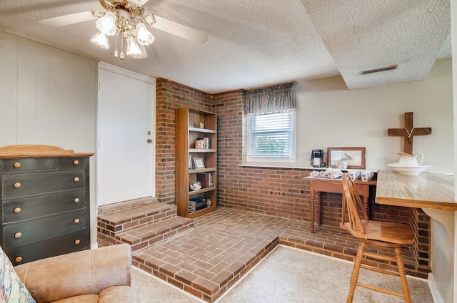 office featuring ceiling fan and a textured ceiling