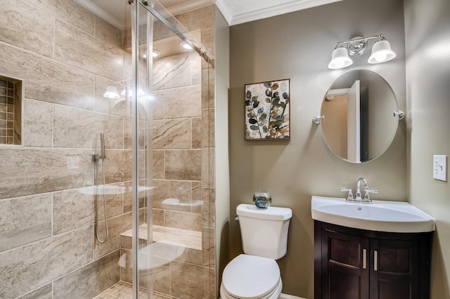 bathroom with vanity, toilet, a shower with door, and ornamental molding