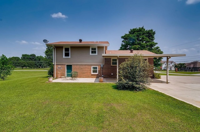 back of house featuring a yard and a patio area