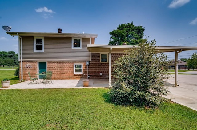 rear view of house featuring a patio area and a yard