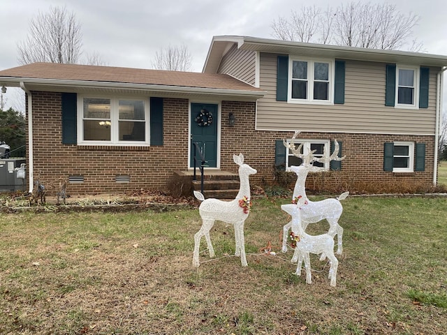 tri-level home with a front lawn