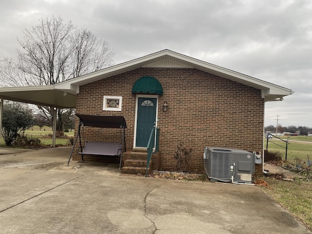 view of front of property with a carport and cooling unit