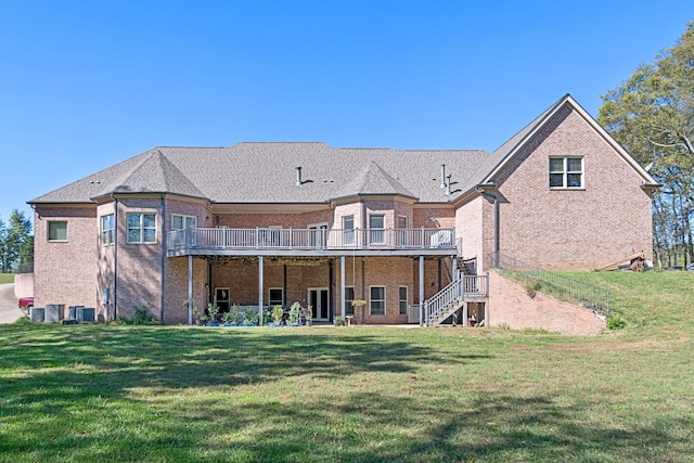 rear view of house with a lawn, central AC, and a deck