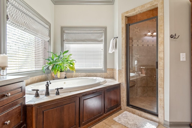 bathroom with tile patterned flooring, vanity, and separate shower and tub