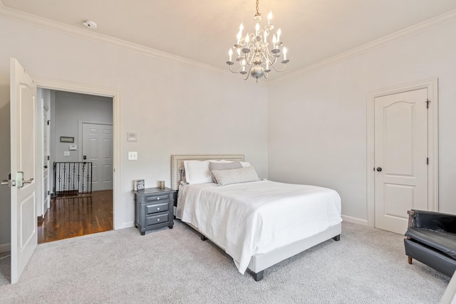 carpeted bedroom featuring crown molding and an inviting chandelier