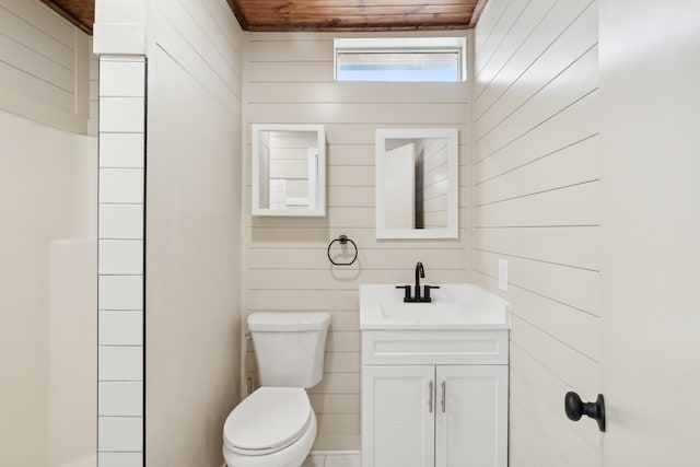 bathroom with wooden walls, vanity, wood ceiling, and toilet