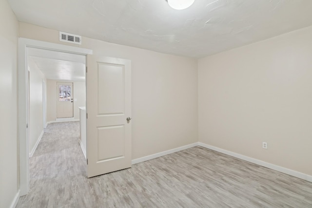 unfurnished room with light hardwood / wood-style flooring