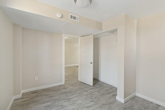 empty room with light hardwood / wood-style floors