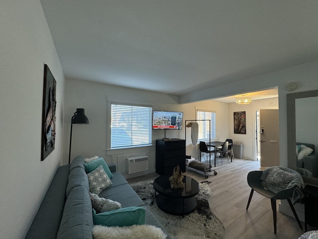 living room featuring a healthy amount of sunlight and a wall unit AC