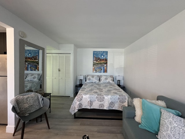 bedroom with hardwood / wood-style flooring and a closet