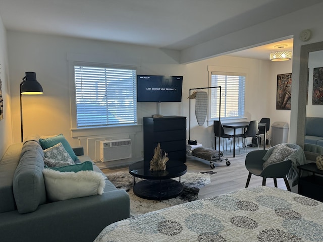 living room with wood-type flooring and a wall mounted AC