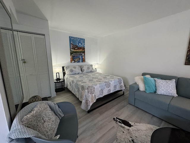 bedroom with hardwood / wood-style floors and a closet