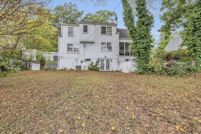 rear view of property featuring french doors and a sunroom