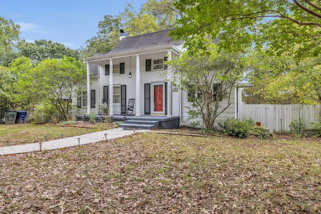 view of front of home with covered porch and a front yard